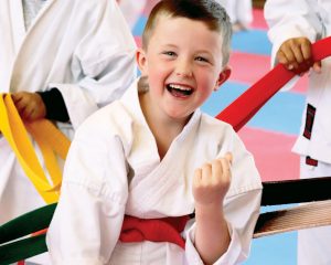 happy red belt karate student laughing
