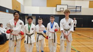 5 different karate students with medals and certificate of participation