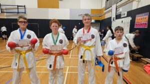 4 gkr karate students with certificate of participation