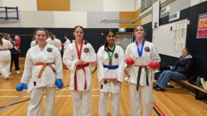 four karate students with their certificates of participation