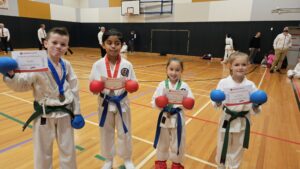 four gkr karate students with certificate of participation