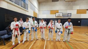 seven karate students with medals and certificate of participation