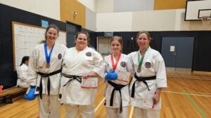 four karate students with medals