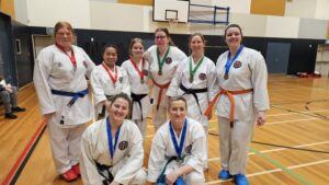 a group of karate students with medals