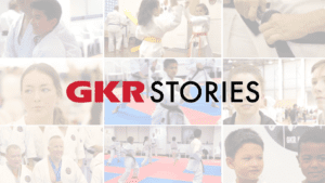 gkr stories logo with images of people performing karate in the background