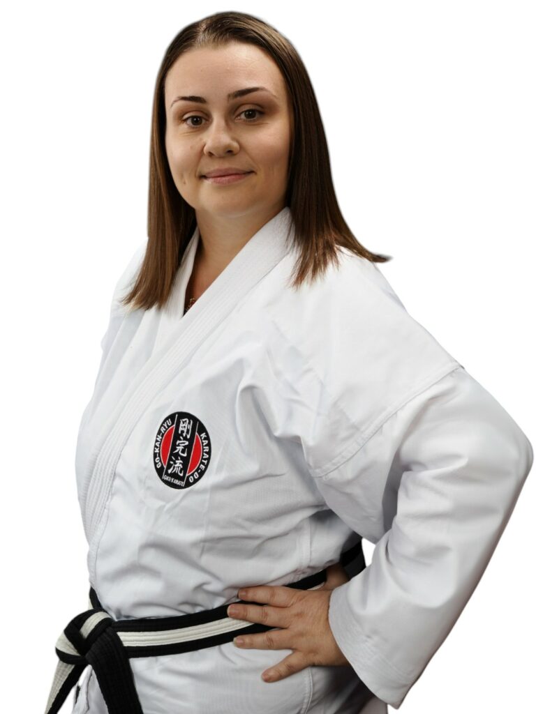 Photo of a woman with dark hair wearing a gi with a GKR Karate badge